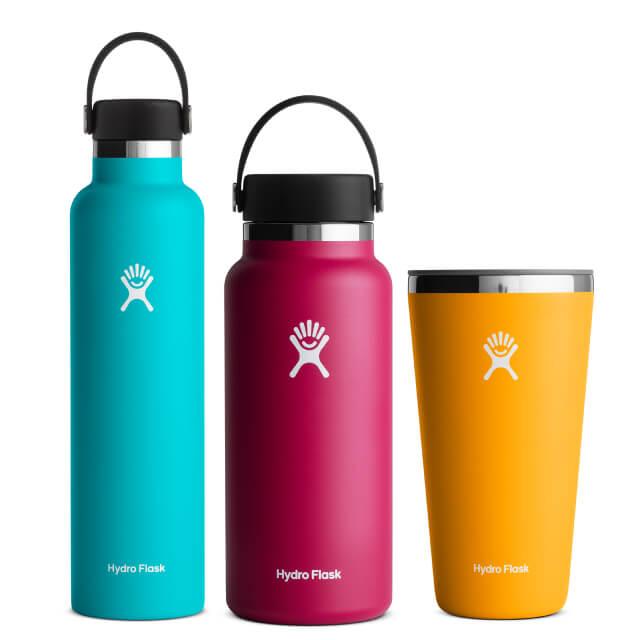 three hydro flask water bottles in a row
