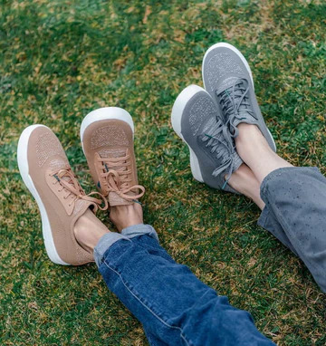 2 friends wearing waterproof shoes on the grass