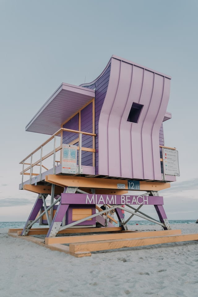 Pink shack on the beach in Miami with word "Miami Beach"