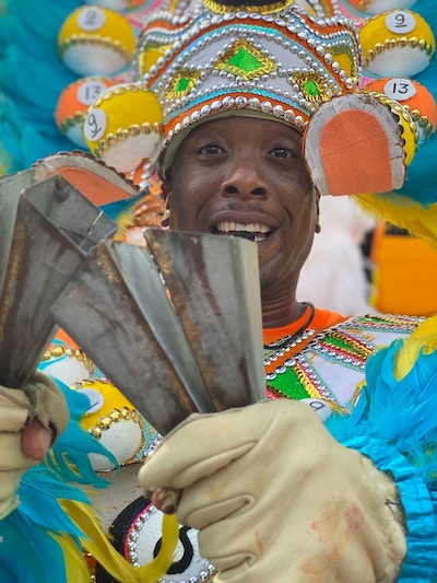 Man celebrating Junkanoo festival wearing traditional clothing