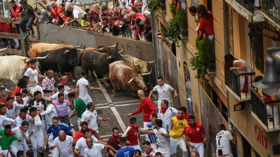 Participants run ahead of bulls during the “encierro” (bull run)