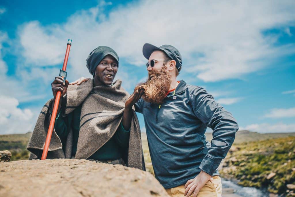 A Solo Traveler Speaking To A Local Person In South Africa