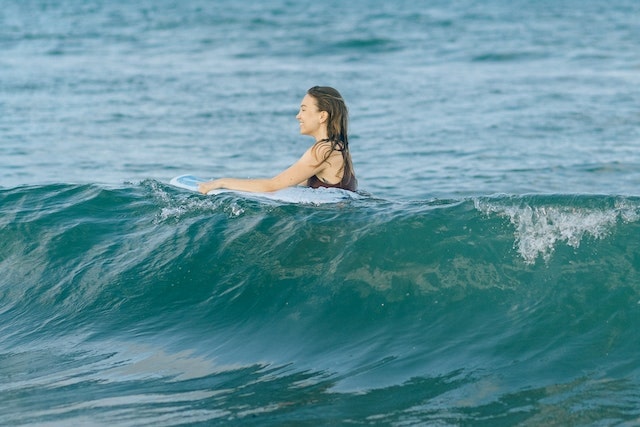 Woman smiling while surfing on waves