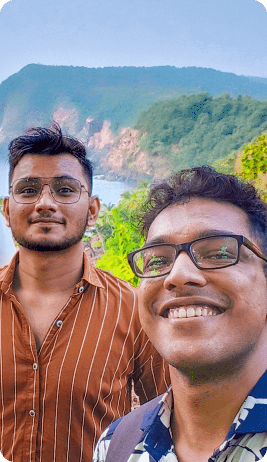 selfie of two males with a mountain backdrop