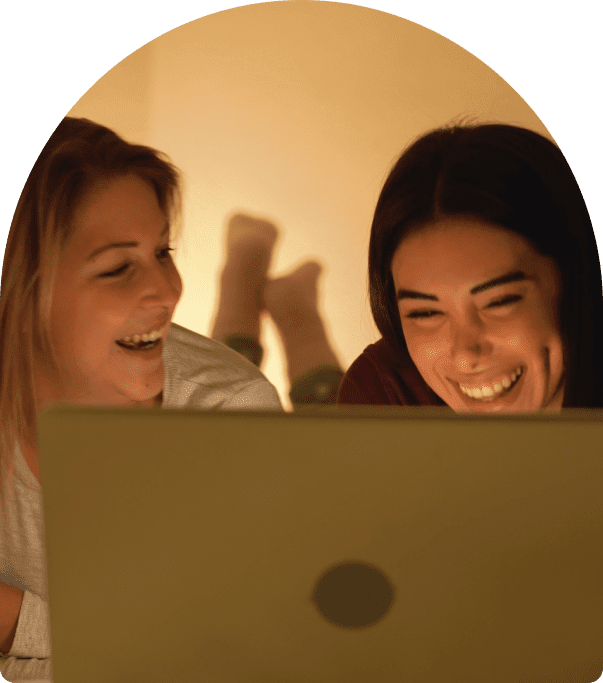 two friends looking at a laptop
